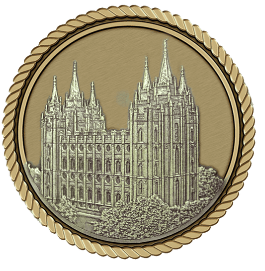 A gold medal with a picture of the salt lake temple.