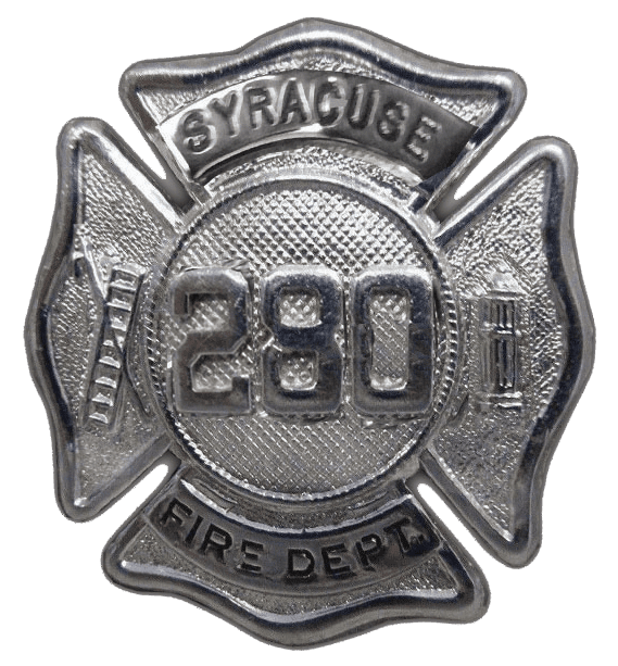 A silver fire department badge with the words syracuse fire dept.