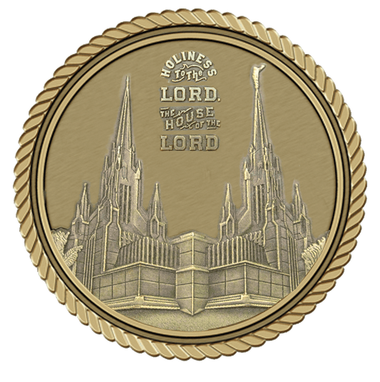 A gold medal with the image of an old church.