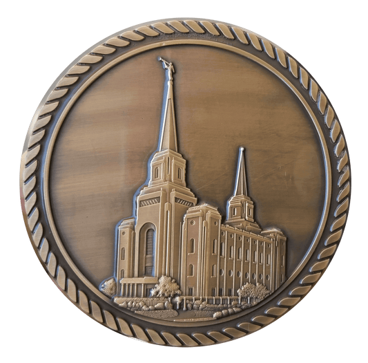 A bronze medal with the image of an lds temple.