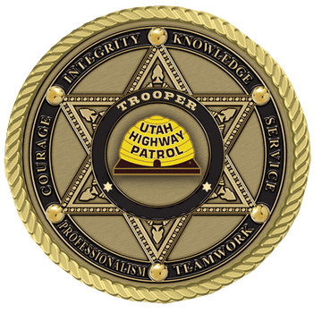 A gold colored badge with the words " trooper utah highway patrol."