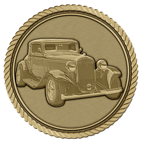 A gold medal with an old car on it