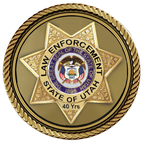 A badge that says law enforcement state of utah 4 0 years.