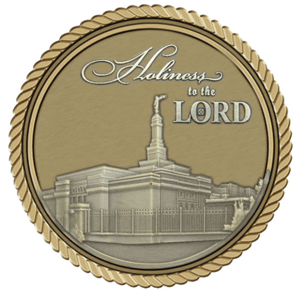 A gold and silver coin with the words holiness to the lord on it.