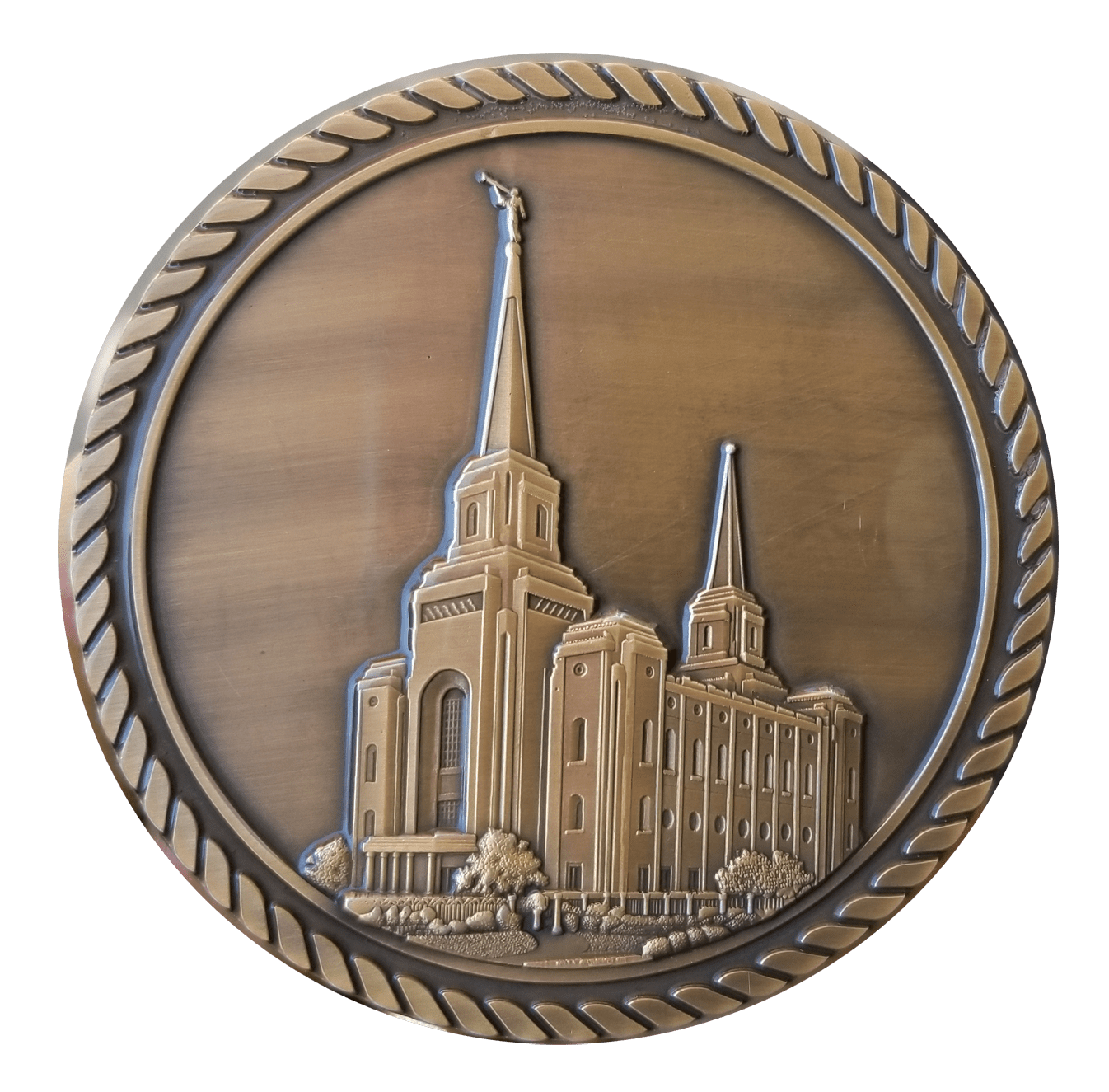 A bronze medal with the image of an lds temple.